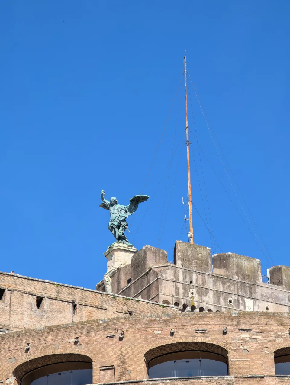 Engelsstatue auf der Engelsburg vor blauem Morgenhimmel